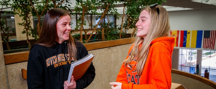 Students talking near stairwell Students talking near stairwell